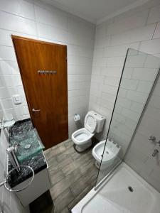 a bathroom with a toilet and a shower and a sink at Los Olivos in Federación