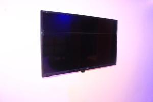 a flat screen tv hanging on a wall at Rungwe City Hotel in Dar es Salaam