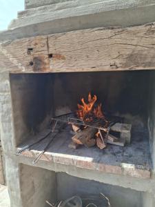a brick oven with a fire in it at Ciruelos del Sur - San Rafael Mendoza in San Rafael