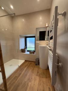 Un baño con ducha, lavabo y espejo. en La Longère - Gîte 4 étoiles, en Alleyrat 28 fotos más