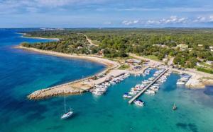an aerial view of a marina with boats in the water at Charming flat with shared pool in Peroj