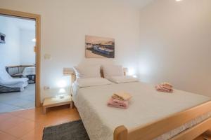 a bedroom with a bed with two towels on it at Villa Dorijana, a beachfront holiday home in Plomin
