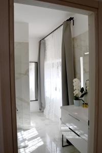 a white bathroom with a mirror and a sink at La Rocca sui Trabocchi in Rocca San Giovanni +20 photos