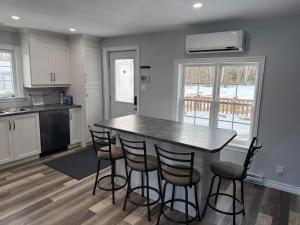 a kitchen with a table and stools in it at Holiday House in Bathurst