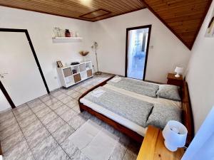 a bedroom with a large bed and a window at Chill Apartman in Balatonfüred