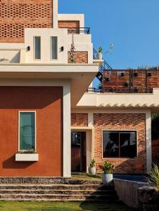 a brick house with a balcony on top of it at Villa with Private Pool, 12 mins walk to Beach in Trincomalee +21 photos