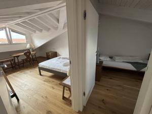 a room with two beds and a table and chairs at Residence Lario Village in Colico +29 photos