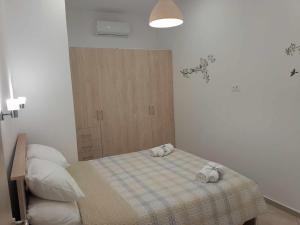 a bedroom with a bed with two towels on it at The Getaway in Agia Marina Nea Kydonias
