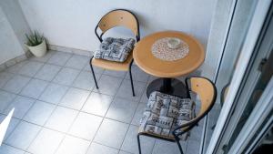 a table and chairs with a cup of coffee on it at Apartman Marito in Kaštela +8 photos