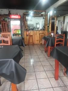 a restaurant with tables and chairs and a bar at Asenjo Paola in Santiago