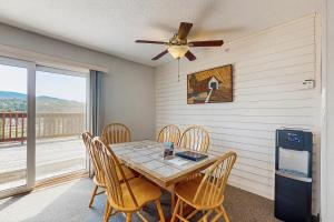 a dining room with a table and chairs and a ceiling fan at Mountainside Resort F302 in Stowe