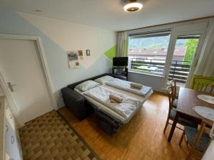 a small room with a bed and a table at Apartma Marjeta in Bovec