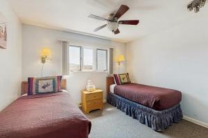 a bedroom with two beds and a ceiling fan at Mountainside Resort F302 in Stowe +63 photos