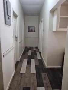 a hallway with a checkered floor and white walls at 2 bedroom house in Tema in Tema