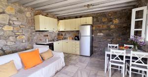 a living room with a couch and a kitchen at Serifos Rock Villa in Serifos Chora