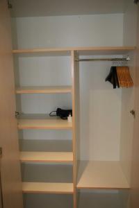 a closet with wooden shelves in a room at Beim See in Grindelwald