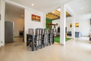 a dining room and kitchen with a table and chairs at d villa galle in Galle