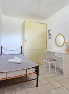 a bedroom with a bed with a mirror and a closet at Serifos Rock Villa in Serifos Chora