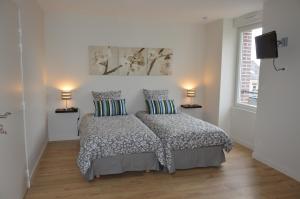 a bedroom with a bed with two pillows at Les Agîtés in Bain-de-Bretagne