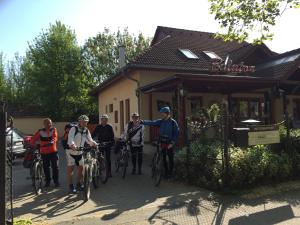 a group of people on bikes in front of a building at Balaton Kinizsi Apartman in Siófok