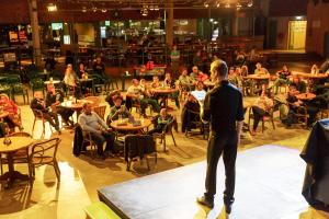a man standing on a stage in front of a crowd at Center Parcs Huttenheugte Drenthe-Overijssel in Dalen +82 photos