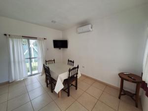 a dining room with a table and chairs and a tv at La Cañada in Juana Koslay 