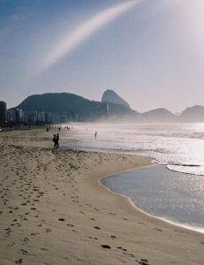 a group of people walking on the beach at VILA LEME Casa 11 in Rio de Janeiro +22 photos