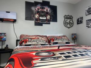 a bedroom with a bed with a car on the wall at Blue Mountain Retreat in Elgin