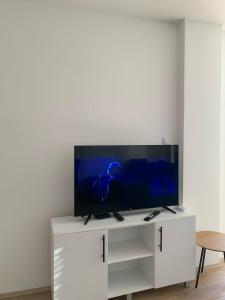 a white entertainment center with a flat screen tv on it at Vilimon in Prokuplje