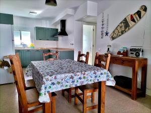a kitchen with a dining room table and a table and chairs at Comodidad en AGUAMARGA! in Agua Amarga