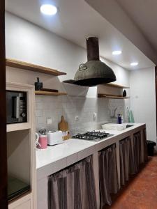 a kitchen with a stove and a stove top oven at Central Apartment with view, 2 bedrooms, living room, kitchen, 1 bathroom in Saint-Louis