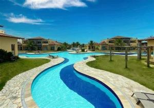 a swimming pool with blue water in a resort at Buzios Beach Resort in Búzios