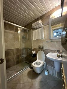 a bathroom with a toilet and a shower and a sink at Barby Butik Otel in Kemer +63 photos