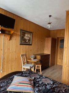 a bedroom with a bed and a table and a desk at Pokoje u Walkoszów in Ząb