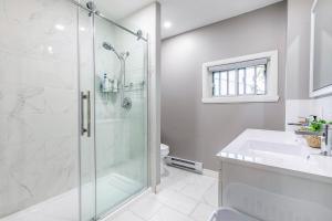 a bathroom with a shower and a sink at Three bedroom apartment Free parking EV charger in Longueuil +11 photos