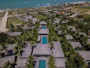 an aerial view of a resort with palm trees at Hotel VilaVeraTheresa in Fortim