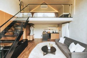 a living room with a couch and a loft at NÖR Hotel & SPA in São Roque