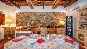 a kitchen with a table and a stone wall at B&B Toringo in Capannori +20 photos