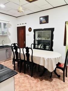 a dining room with a table and chairs at Dona's Villa Coastal House in Pamunugama in Negombo