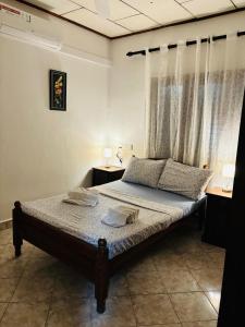 a bedroom with a bed with two dishes on it at Dona's Villa Coastal House in Pamunugama in Negombo