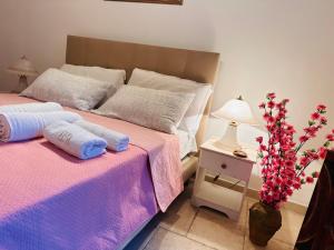 a bedroom with two beds and a table with a lamp at Dimora Iryna in Monopoli