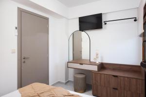 a bedroom with a sink and a mirror at Opalium Beach Front Suites in Potos