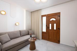 a living room with a couch and a table at Opalium Beach Front Suites in Potos