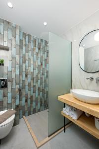 a bathroom with a sink and a mirror at Opalium Beach Front Suites in Potos