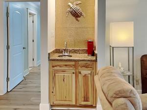 a living room with a sink and a couch at Smiling Jacks Escape in Mustang Beach +36 photos