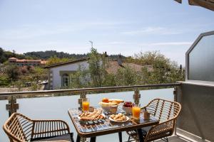a table with food and drinks on a balcony at Opalium Beach Front Suites in Potos
