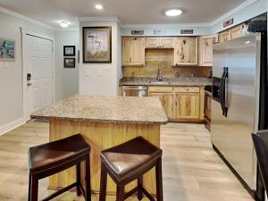 a kitchen with a counter and a refrigerator at Smiling Jacks Escape in Mustang Beach