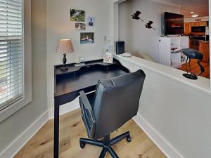 a office with a desk with a chair and a lamp at Smiling Jacks Escape in Mustang Beach