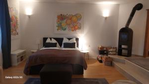 a bedroom with a large bed and a fireplace at Apartment FreiRaum in Innsbruck