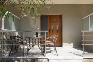 a table and chairs on a balcony with a door at Opalium Beach Front Suites in Potos